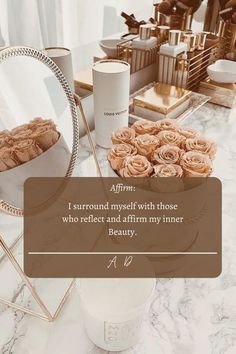 a table topped with cakes and flowers on top of a white marble counter next to a mirror