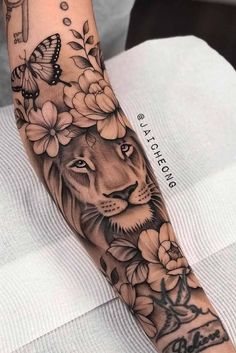 a lion with flowers and butterflies on his arm