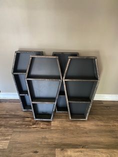 two metal shelvings sitting on top of a wooden floor