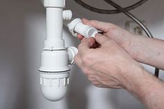 a person is fixing an electrical outlet on a wall