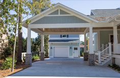 a large house with two garages in front of it