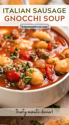 italian sausage and gnocchi soup in a white bowl with bread on the side