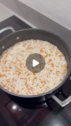 a frying pan filled with rice on top of a stove