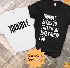 NOTE: SHIPPING ESTIMATES ARE BASED ON BUSINESS DAYS & EXCLUDE WEEKENDS/HOLIDAYS. PLEASE ALLOW up to 10 BUSINESS DAYS for your package to arrive. ORDERS made after Dec 9th may not  arrive before Christmas. Orders will still be processed after that date, so please take this into consideration when shopping. Thank you for your understanding! The "Trouble" T-shirt, with its bold and grunge-style text, sets the stage for some mischievous fun as part of a Funny Matching Couples T-Shirt ensemble. Paire Funny Matching T Shirts, Matching Couples Shirts, Halloween Shirts Couples, Couple Tshirts Funny, Cheap Family Shirt With Funny Text, Funny Halloween Shirts For Couples, Funny Pre-shrunk Family T-shirt, Cursed Couple Shirts, Matching Sibling Shirts