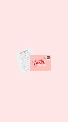 a pink credit card with the word santa written on it next to a white envelope