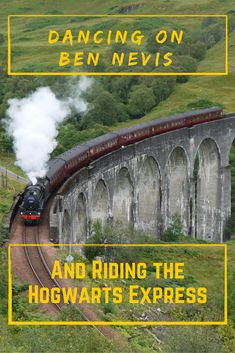 a train traveling down tracks next to a lush green hillside