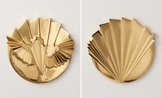 two gold plates with fan shaped designs on them