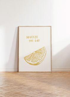 a framed poster with the words squeezeeze the day written in gold on it