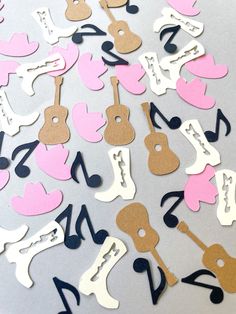 a table topped with lots of cut out hearts and musical instruments on top of each other