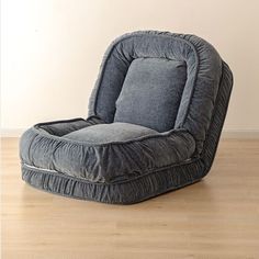 a grey chair sitting on top of a hard wood floor