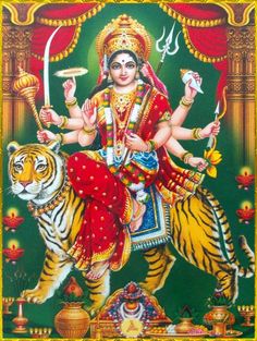 the hindu goddess sitting on top of a tiger