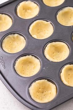 an uncooked muffin tin filled with some kind of pastry crust in it