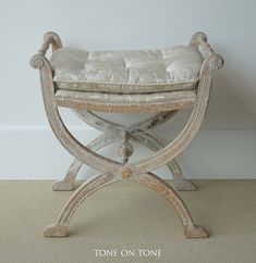 a white bench sitting on top of a carpeted floor