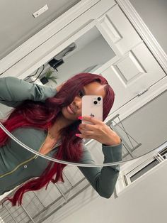 a woman with red hair taking a selfie