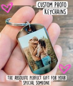 a person holding a keychain with the words, custom photo key chains it's the absolute perfect gift for your special someone