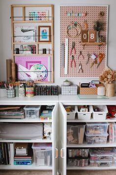 an organized craft room with lots of crafting supplies on the shelves and storage bins