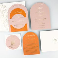 the wedding stationery is laid out on top of each other