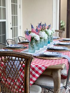 the table is set with red, white and blue place settings for fourth of july