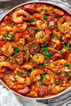 a large pan filled with shrimp and sausage