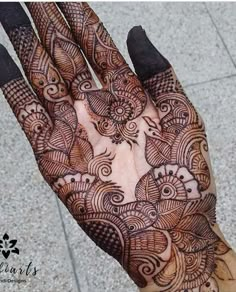 the hand is decorated with intricate designs on it