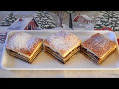 four pastries on a white plate in front of a christmas tree and snow scene