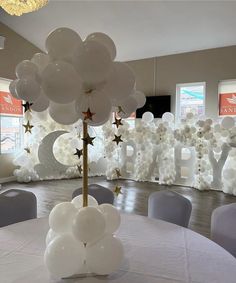 balloons and stars decorate the centerpieces for an event