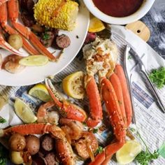 lobsters, corn on the cob and potatoes are served with dipping sauce