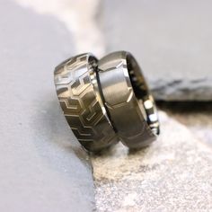 two wedding rings sitting on top of each other