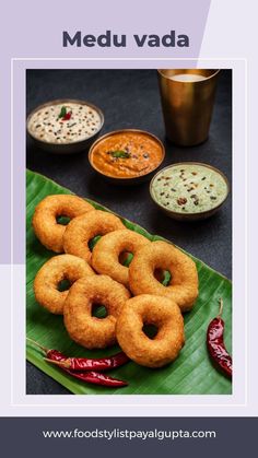 some food is sitting on a green leaf and there are sauces in the background