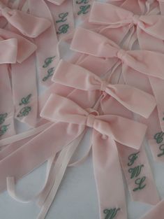 pink satin ribbons with green writing on them