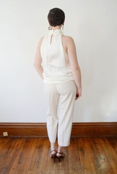 "Description: Shimmery off white blouse that buttons up the back of the neck with crystal buttons. Measurements of garment, allow space for fit. Bust: 43\" Length: 25\" I take my measurements flat, and double for circumference. Tag: Chaus Fabric: Silky polyester Condition: Excellent Follow along on instagram @lovecharlesvintage" Off White Blouse, Turtleneck Blouse, Crystal Buttons, Sleeveless Turtleneck, Grand Rapids Mi, Grand Rapids, White Blouse, Sundress, Vintage Dresses