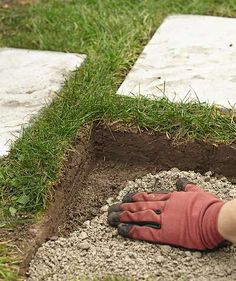 someone is digging in the ground with gloves on