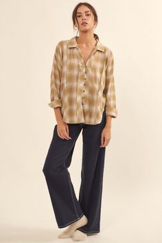 Plaid cotton shirt. Exposed seams throughout with raw-edge detailing. Collared V neckline. Button loop closure. Long sleeves with buttoned cuffs. Dolphin hem. Relaxed fit. 100% Cotton. Imported. Designed in LA. Model wears size S. Cotton Button Tops For Fall, Cotton Tops With Buttons For Fall, Fall Cotton Tops With Button Closure, Relaxed Fall Shirt For Everyday Wear, Relaxed Everyday Shirt For Fall, Relaxed Everyday Fall Shirt, Cotton Tops With Button Closure For Fall, Chic Plaid Cotton Shirt, Casual Cotton Blouse With Button Closure