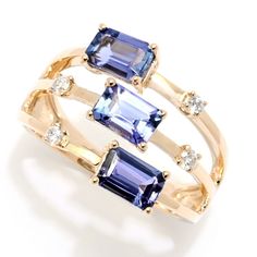 Step into the style spotlight with this magnificent 1.80 carat CIRARI ring. You'll love the gorgeous color, sparkle and gleam! The split band design showcases three 6x4mm emerald-cut AAA tanzanite gemstones arranged East-West. The luxurious piece is also adorned with four brilliant-cut round diamonds. It's finely crafted in 14K yellow gold with a brilliant polished finish. It will effortlessly elevate any style, whether you're going casual or dressing up. You'll want to wear this beauty all the Stock Design, Tanzanite Diamond Ring, Tanzanite Diamond, Band Design, All Gems, Tanzanite Ring, Tanzanite Gemstone, Tourmaline Ring, I Love Jewelry