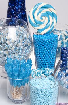 blue and white candies in glass vases with candy canes on the side