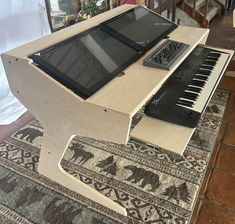 an electronic keyboard sitting on top of a wooden table next to a tabletop piano