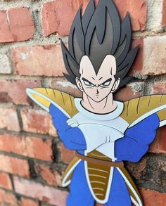 a paper cut out of the character gohan on a brick wall