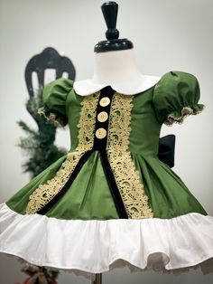 "This elf dress is perfect for santa photos! This dress is made to look like an elf suit. It is adorned with gold trim, gold buttons and black velvet trim for a very lux appearance. Hemline has cute white ruffle and back has big black bow. Pictured with a petticoat. Not included in price but available as separate purchase in our shop. Runs a touch small. I would recommend sizing up if in between sizes. Please see size chart attached. Size chart reflects measurements of your child, not measuremen Infant Elf Costume, Christmas Elf Costume Ideas, Elf Suit, Christmas Elf Outfit, Christmas Elf Costume, Christmas Dress Up, Goose Clothes, Elf Dress, Patterns For Fashion