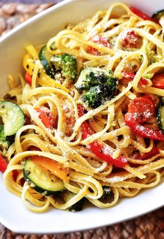 a white bowl filled with pasta and vegetables