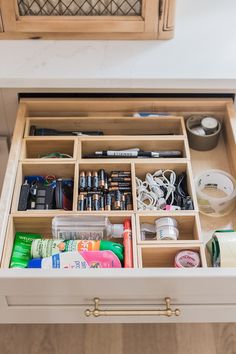 an open drawer with many items in it