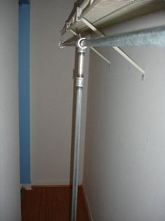 the corner of a room with a metal pole