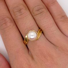 This sleek design makes this ring suitable for any outfit. It can be worn to a nice event or as a day-to-day piece. The asymmetrical band makes this ring unique while still keeping a simple design. Metal Quality: 18K Yellow GoldGemstone: Genuine Culture PearlGemstone Color: WhiteGemstone Shape: RoundPearl Measurements: 8.39mmBand Width: 4.05mmRing Size: 9 Luxury Yellow Gold Pearl Ring For Anniversary, Pearl Rings In Gold Simple, Luxury Gold Open Pearl Ring, Pearl Rings In Gold, Unique Gold Rings, Bridal Necklace Designs, Cultured Pearl Ring, Estate Ring, Estate Rings