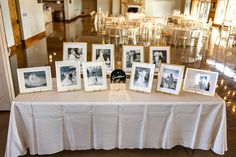 a table topped with pictures and framed photos