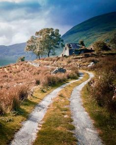 a path leading to a house in the mountains