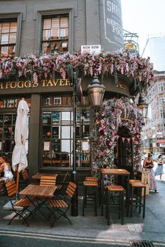 the outside of a restaurant with tables and chairs