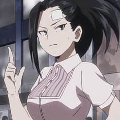 an anime character with black hair pointing to the side and holding her hand up in front of her face