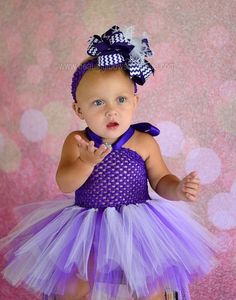 Your little girl will be “tutu” fabulous in this precious purple and white baby and toddler tutu dress from Beautiful Bows Boutique. Custom handmade to perfection, it features a berrylicious purple crocheted halter top with a billowing ombre tutu in coordinating tulle. The effect is downright magical! Add a shabby-adorable element to her wardrobe with this versatile children’s tutu dress that can be worn on a variety of occasions. Top off her look with one of our signature hair bows to match per Purple Fitted Princess Dress With Ruffles, Purple Cute Tutu Dress For First Birthday, Cute Purple Tutu Dress For First Birthday, Purple Princess Tutu Dress For First Birthday, Playful Purple Princess Dress For Summer, Cute Purple Tutu Dress For Birthday, Purple Cute Tutu Dress For Birthday, Cute Purple Princess Dress With Ruffles, Purple Tulle Tutu Dress For Birthday