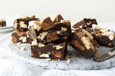 pieces of chocolate and marshmallow fudge cake on a plate with a fork