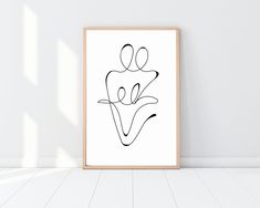 a black and white drawing on a wall next to a wooden framed art print that says love