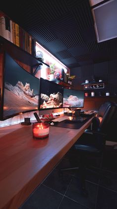 a desk with a computer monitor on it and a lit candle in front of it